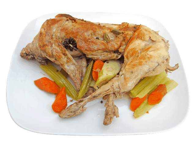 A cooked rabbit meat dish prepared in a restaurant setting