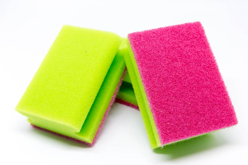 A scouring pad for scrubbing calcium carbonate urine stains from rabbit cages and litter trays.